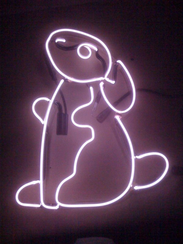 Neon outline of a sitting dog glowing pale pink